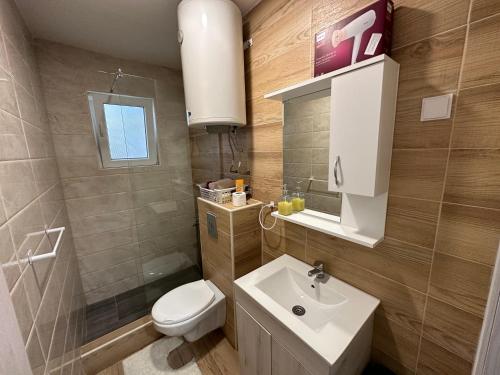 a bathroom with a white sink and a toilet at Vucinic Studio Apartment in Cetinje