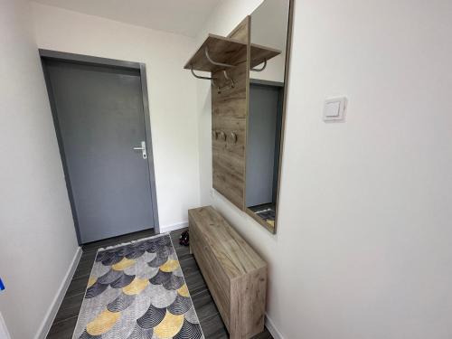 a bathroom with a mirror and a wooden bench at Vucinic Studio Apartment in Cetinje