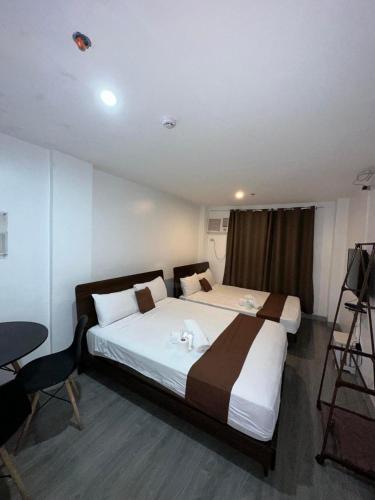a hotel room with a large bed and a camera at Aden Hotel in Manila
