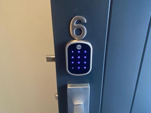 a door with a cell phone sticking out of it at Hamilton Hospital Retreat - 2 Bedroom Townhouse Modern Warm Quiet in Hamilton