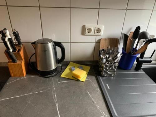 a kitchen counter with a coffee maker on a counter top at Luxus Apartment in duisburg in Duisburg