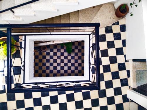 a room with a checkered floor and a window at Dar Gara in Tangier