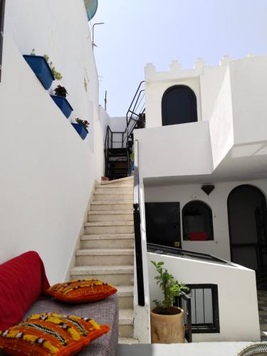 a stairway leading up to a white building with stairs at Dar Gara in Tangier