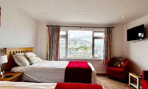 a bedroom with a bed and a large window at Fisherman's Wharf in Brixham
