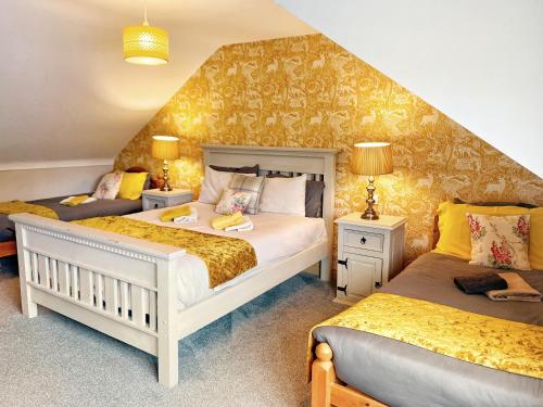 a bedroom with two beds and a staircase at Dulrush Lodge Guest House, Restaurant and Self-Catering in Belleek