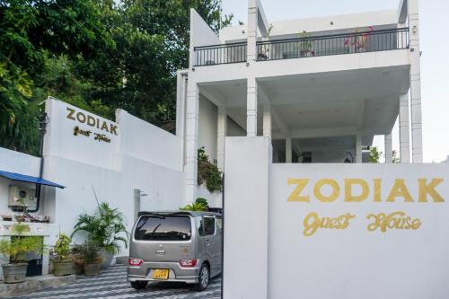 a small van parked in front of a building at Zodiak in Tangalle