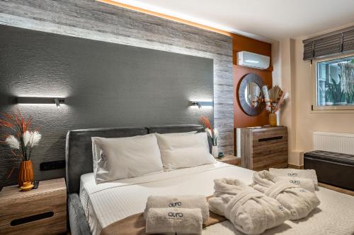 a bedroom with a bed with towels on it at Avra Summer Living _ Private Jacuzzi _ StepstoSea in Agia Pelagia