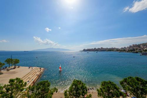 a view of a beach with a boat in the water at Hotel Summer in Sarandë
