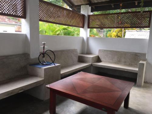 a room with couches and a table with a coffee table at Everdew Kandy Rooms in Kandy