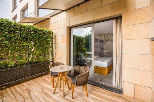 a patio with a table and chairs on a balcony at The Social House Nairobi, a Preferred Lifestyle Hotel in Nairobi