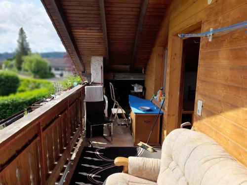 a balcony of a house with a table and chairs at Trochtelfingen F1 in Trochtelfingen