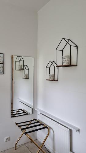 a room with two mirrors and a chair at Guesthouse Galleri Vík in Vík