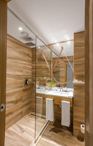 a bathroom with two sinks and a glass wall at The Social House Nairobi, a Preferred Lifestyle Hotel in Nairobi
