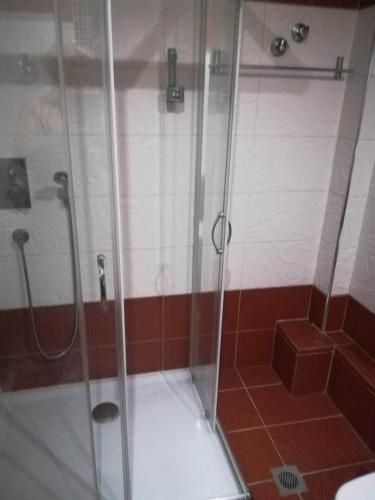 a shower with a glass door in a bathroom at Agathoupoli beach 