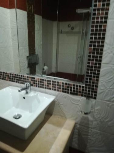 a bathroom with a sink and a mirror at Agathoupoli beach 
