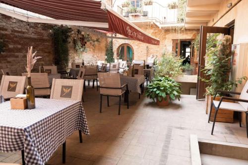 a restaurant with tables and chairs and a brick wall at Apart Yaroslava Osmomysla 9 Square - city center in Lviv