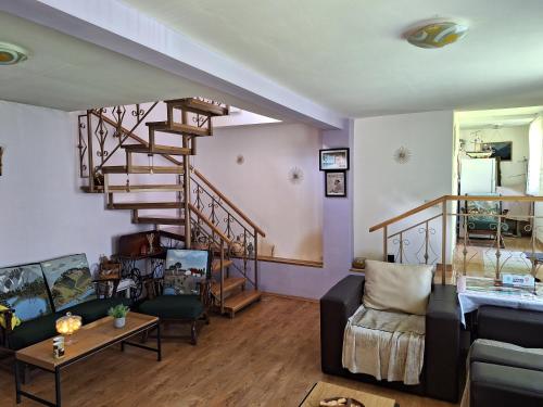 a living room with a spiral staircase and a couch at Casa Delia in Balta