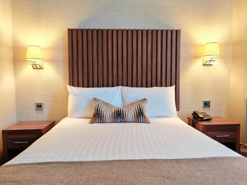 a bedroom with a large bed with two pillows at Frederick House Hotel in Edinburgh