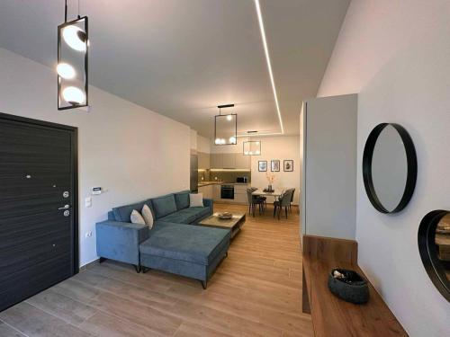 sala de estar con sofá azul y espejo en Elia Luxury Residence, en Chalkida