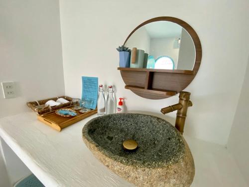 a bathroom sink with a large stone sink at VYA homestay Huế in Thôn Lại Thê