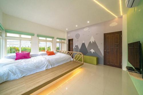 a bedroom with a large bed and a large window at Happy play villa in Yuanshan