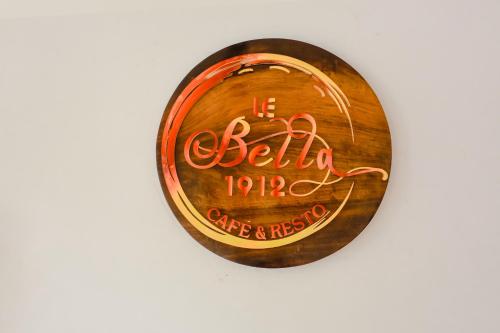 a close up of a wooden circle with a sign on it at le bella1912 in Galle