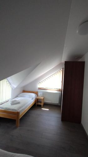 a bedroom with a bed and a window at Apartmány Adam in Liptovská Teplá