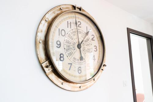 a clock is hanging on a wall at Appartement des Sorcieres - Witches Apartment in Sélestat