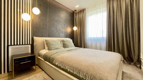 ein Schlafzimmer mit einem großen Bett und einem Fenster in der Unterkunft Luksusowe Apartamenty na Toruńskiej in Kwidzyn
