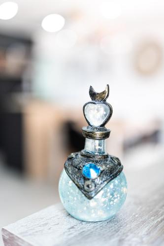 a glass bottle with a bird on top of it at Appartement des Sorcieres - Witches Apartment in Sélestat
