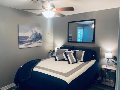 a bedroom with a bed and a ceiling fan at Xscapecation Oasis in Tulsa
