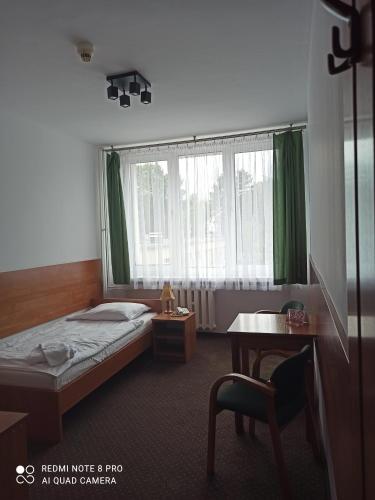 a hotel room with a bed and a window at HOTEL ODR in Sulechów