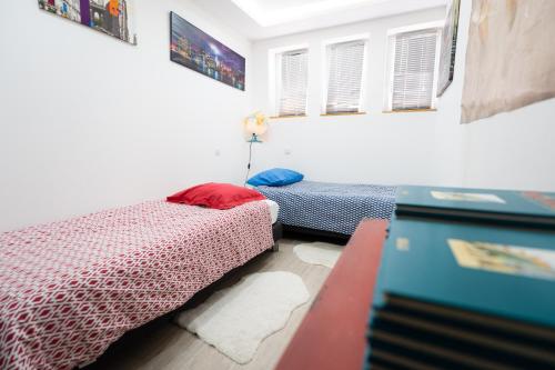 a bedroom with two beds in a room at Appartement des Sorcieres - Witches Apartment in Sélestat