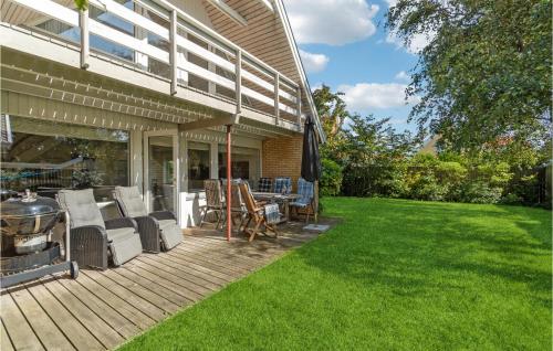 a deck with chairs and a grill on a house at Beautiful Home In Skagen With Wifi in Skagen