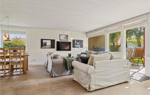 a living room with white furniture and a table at Beautiful Home In Skagen With Wifi in Skagen