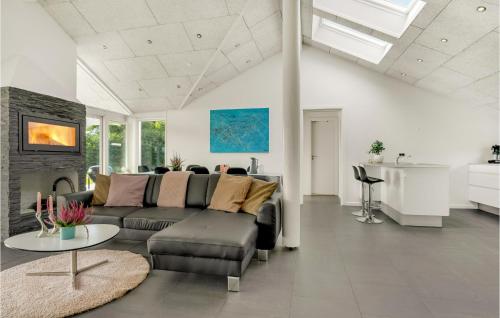 a living room with a couch and a table at Holiday Home Hjørring With Fireplace 02 in Vester Vidstrup