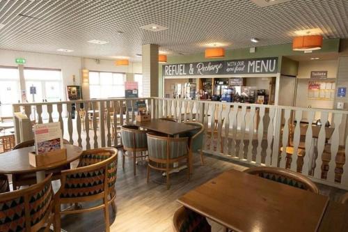 a restaurant with wooden tables and chairs and a bar at 8 person static caravan in Heysham