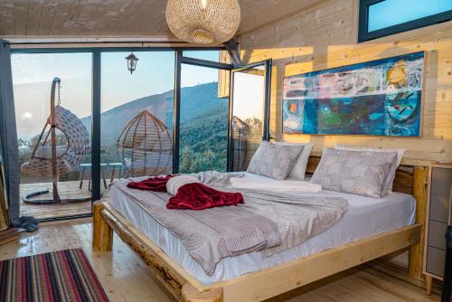 a bed in a room with a large window at Villa Tramonto D'Oro in Ulcinj