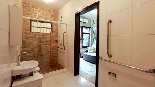 a bathroom with a sink and a toilet and a shower at Solar das Pétalas Guest House in Florianópolis