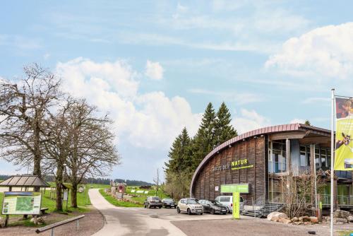 a building with cars parked outside of it at Kaiserchalet in Höchenschwand
