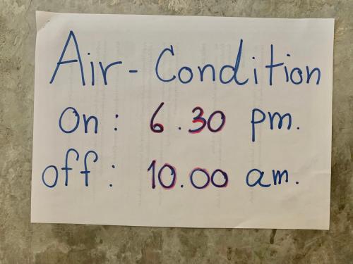 a sign that reads air condition iron on pm at Doze Hostel in Chiang Mai