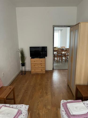 a living room with a television and a table and chairs at Apartment Zámecká in Děčín
