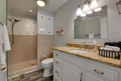 a bathroom with a sink and a toilet and a mirror at Spacious Lake Norman Retreat with Private Dock! in Sherrills Ford