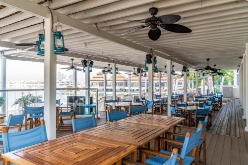 a dining room with wooden tables and blue chairs at Lux BnB I Palm Jumeirah Resort I Palm Views in Dubai