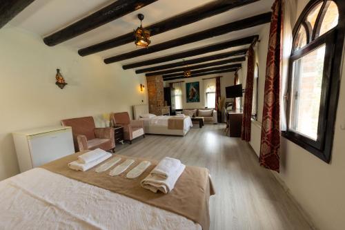 a bedroom with a bed and a living room at Antique Manastir Boutique Hotel in Edremit