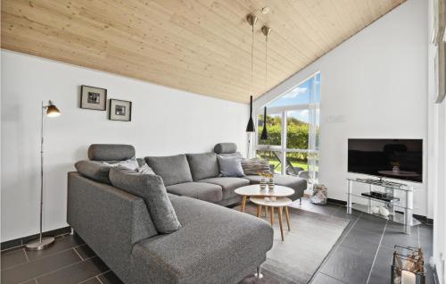 a living room with a couch and a table at Cozy Home In Hemmet With Sauna in Hemmet