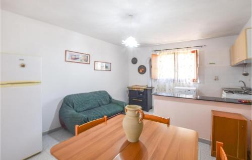 a living room with a vase on a wooden table at Awesome Apartment In Melito Porto Salvo in Melito di Porto Salvo