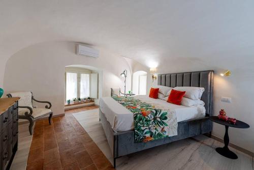 a bedroom with a large bed with red pillows at Loft Corso Cavour in Perugia