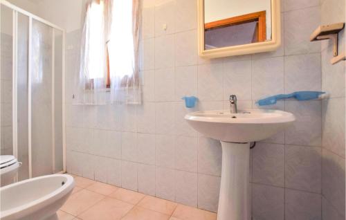 a white bathroom with a sink and a toilet at Awesome Apartment In Melito Porto Salvo in Melito di Porto Salvo