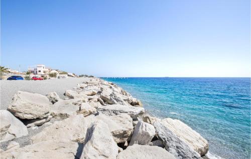 a group of rocks on a beach next to the water at Awesome Apartment In Melito Porto Salvo in Melito di Porto Salvo